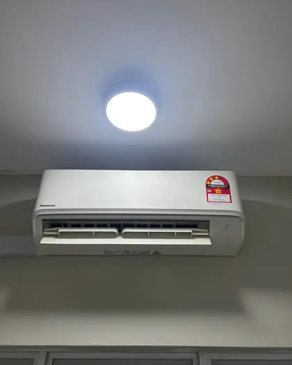 A new white Panasonic wall unit under a ceiling bulkhead and round light